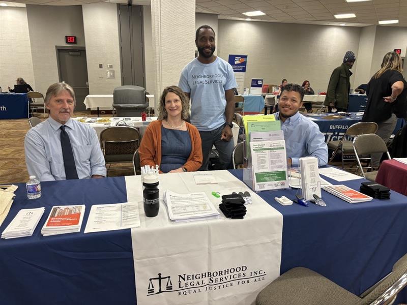 Justice Bus team sitting at table full of resources