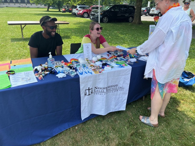 Justice Bus team members at outside tabling event, handing out resources