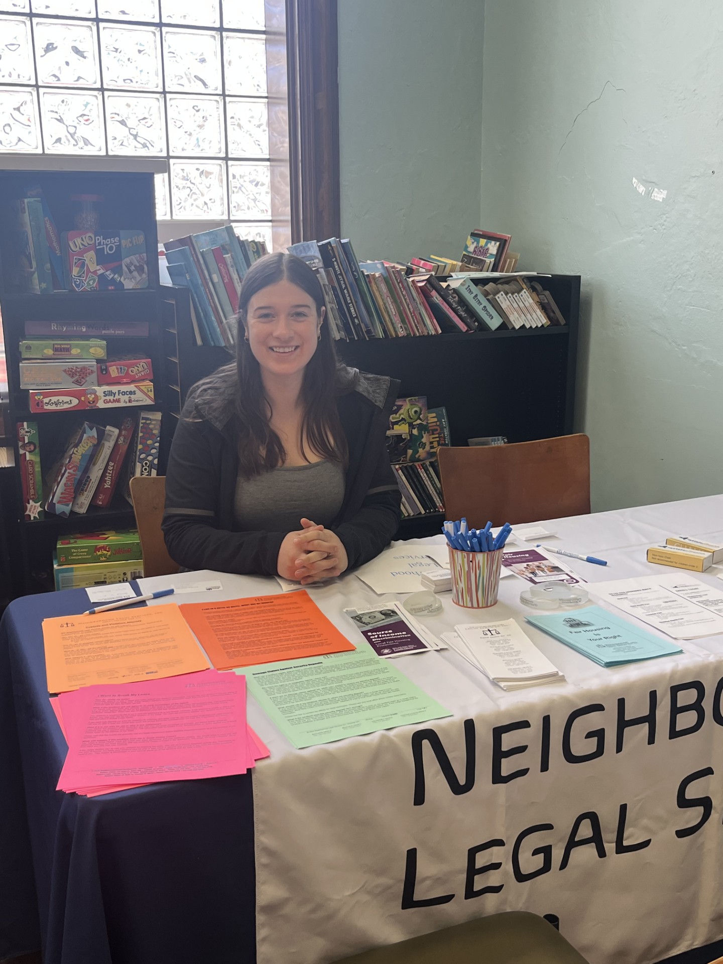 team member sitting at NLS table during event