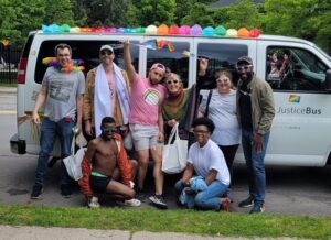 NLS group photo in front of Justice Bus at Pride
