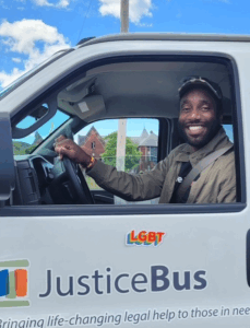 NLS team member driving the Justice Bus 