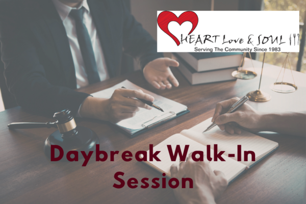 People at a table discussing paperwork with the Heart Love and Soul logo and the words "Daybreak Walk-In Session."