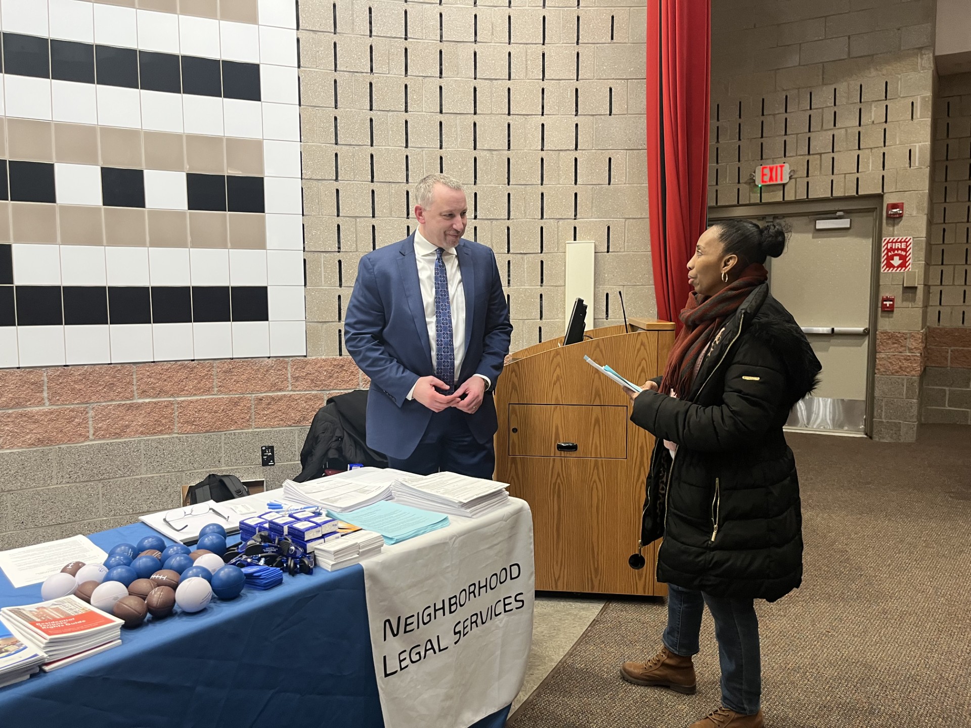 Client speaking to NLS rep at housing event.