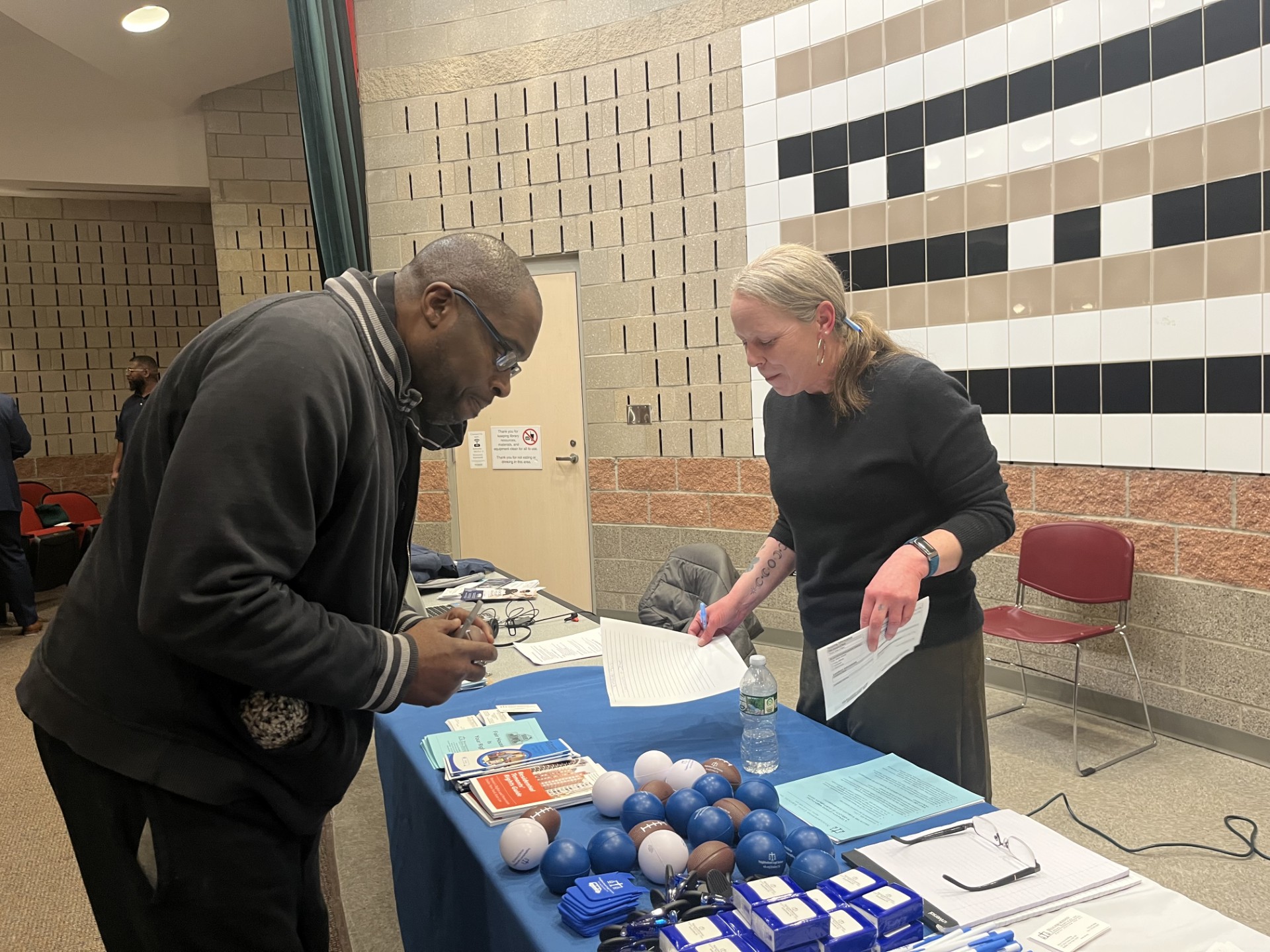 Client picking up resources at housing event.