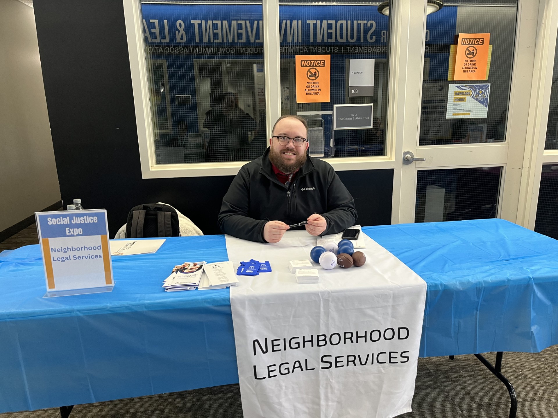 NLS rep at Hilbert College Social Justice Expo tabling event.