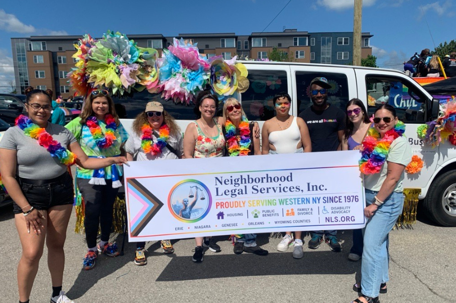 NLS team in front of our Justice Bus decorated for Pride 2026.
