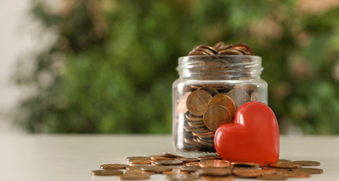 Jar of change with a red heart in front.